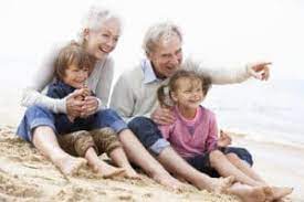 grandparents with grandchildren on beach